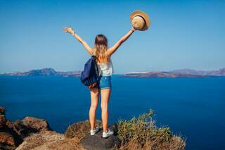 bigstock-Woman-Traveler-Raised-Arms-Fee-462958955