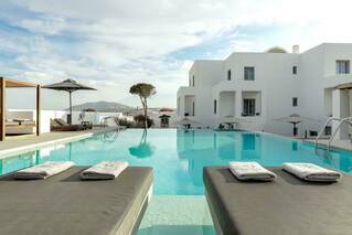 The main swimming pool of Kalisti Hotel & Suites is bound to be a favourite during downtown in between discovering all the romantic things to do in Santorini for couples.